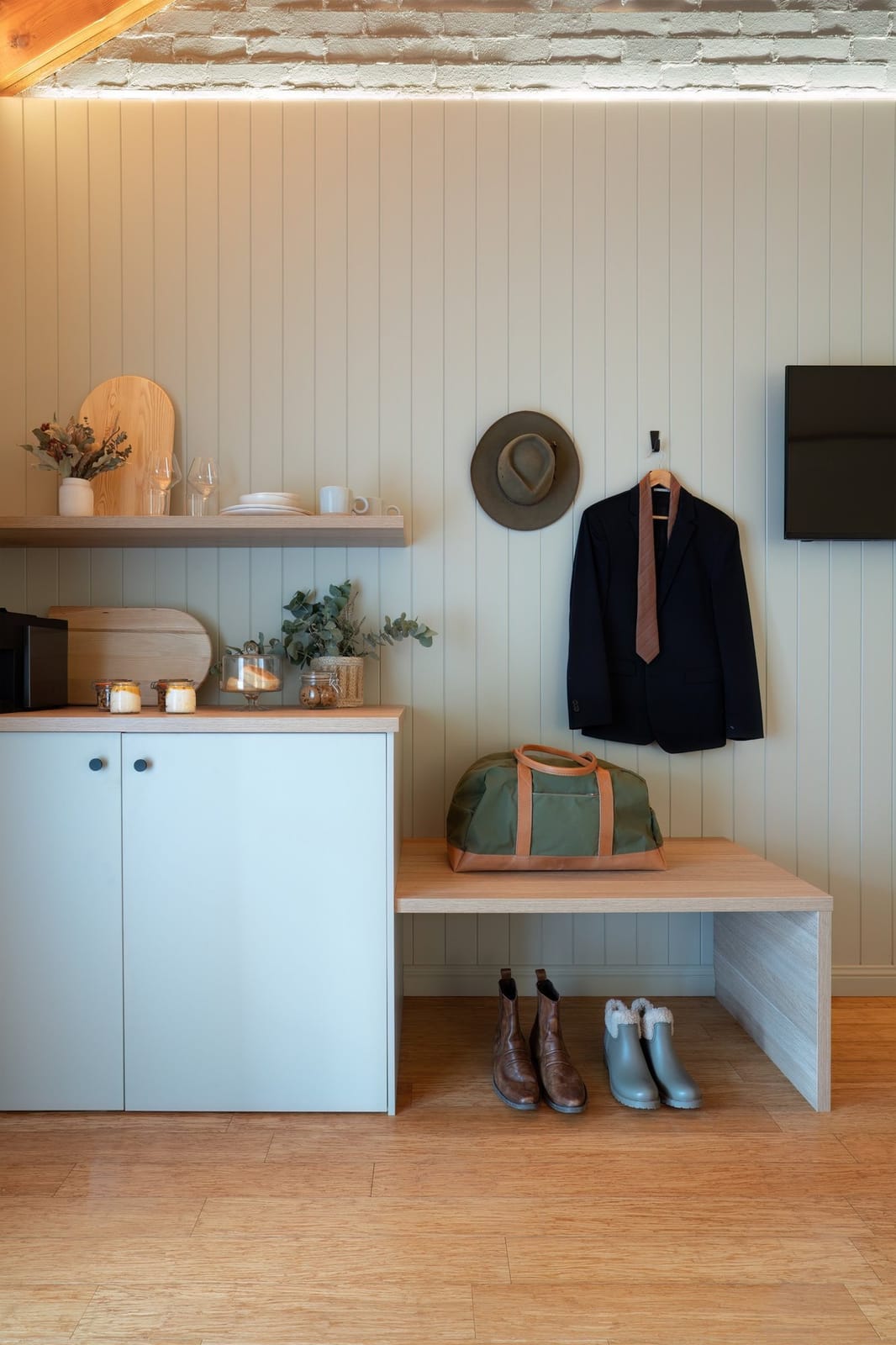 Modern mudroom with white cabinetry, shelving and storage