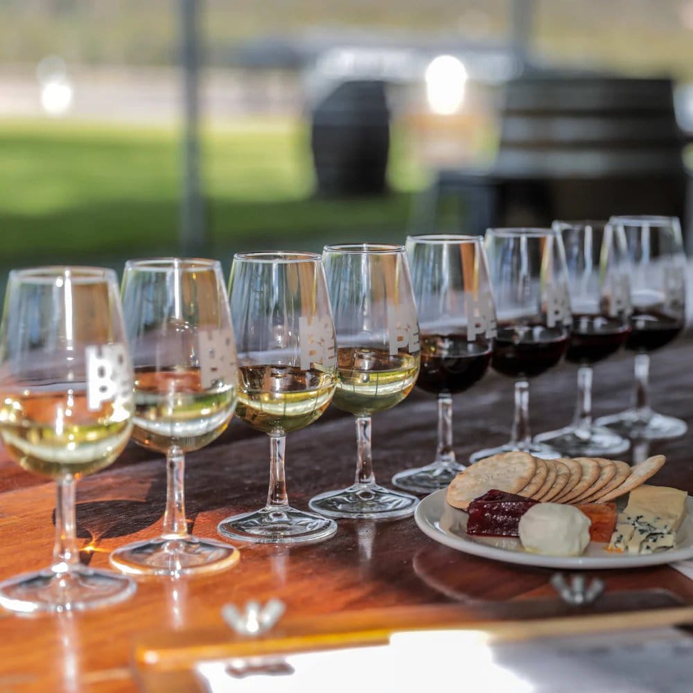 Wine flight tasting with white wines and cheese board