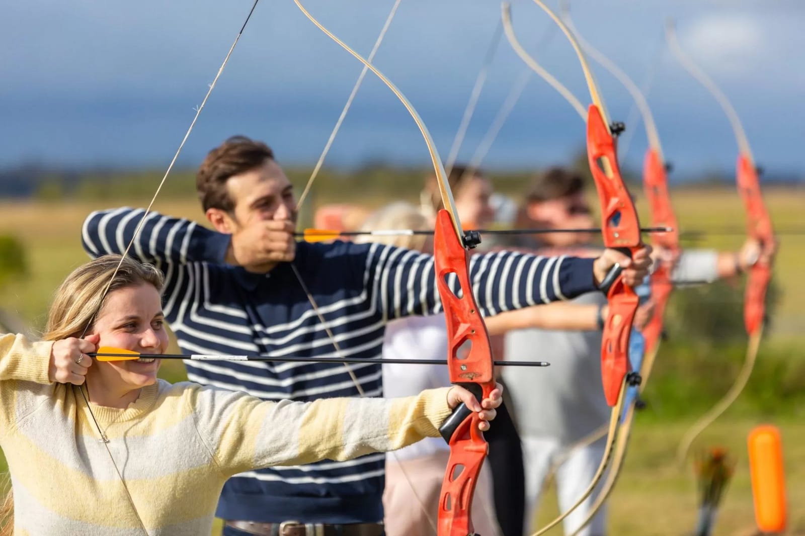 Archers drawing bows outdoors at Hunter Farm & Adventure Centre, Pokolbin