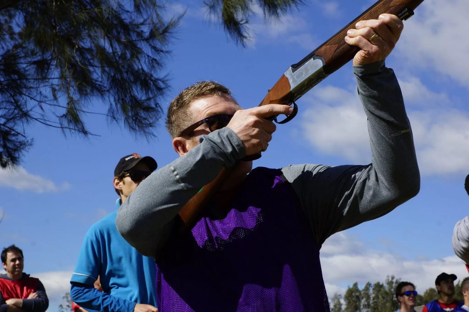 Clay target shooter aiming a shotgun outdoors at Hunter Farm & Adventure Centre, Pokolbin
