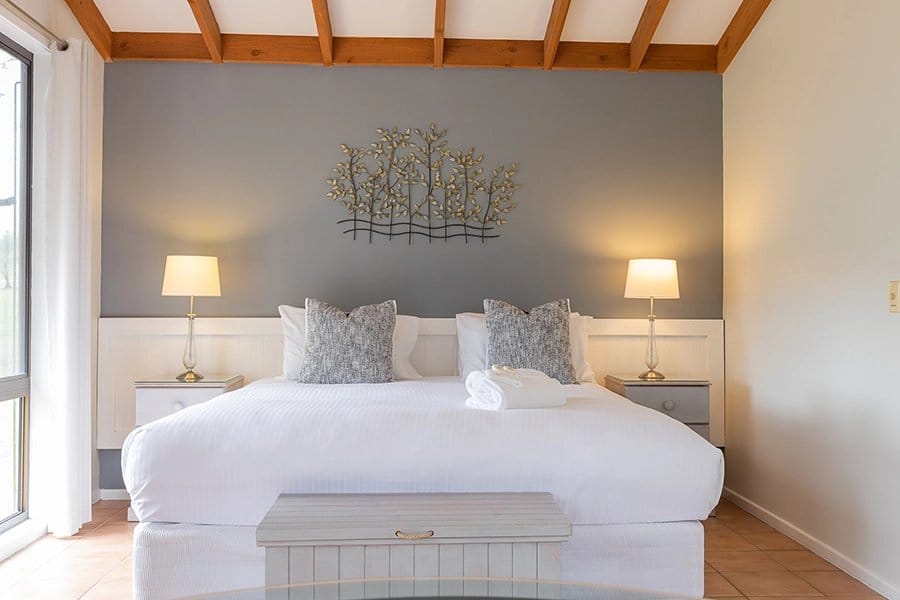King bedroom in the Hunter Gleann cottage with a raked timber ceiling