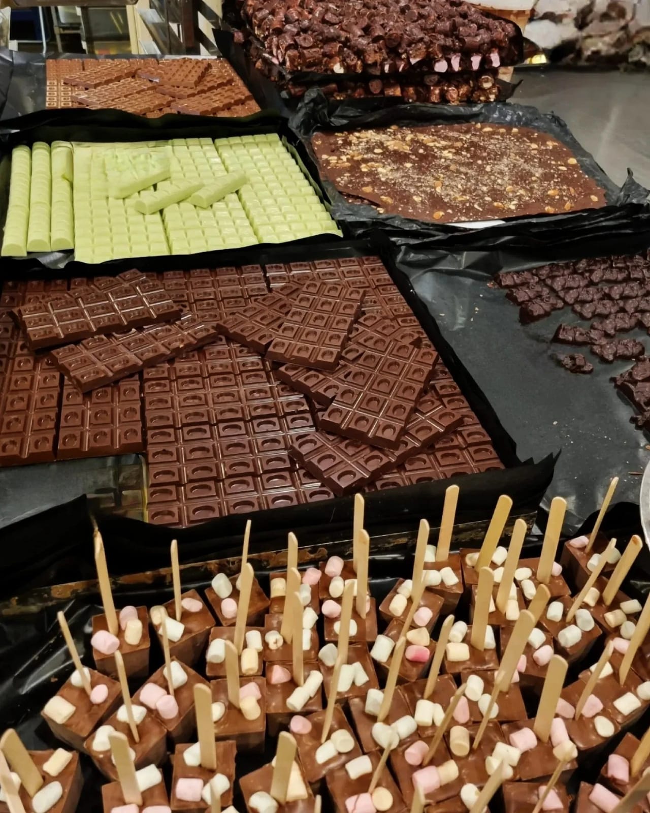 Assortment of chocolate bars, squares and lolly pops on display