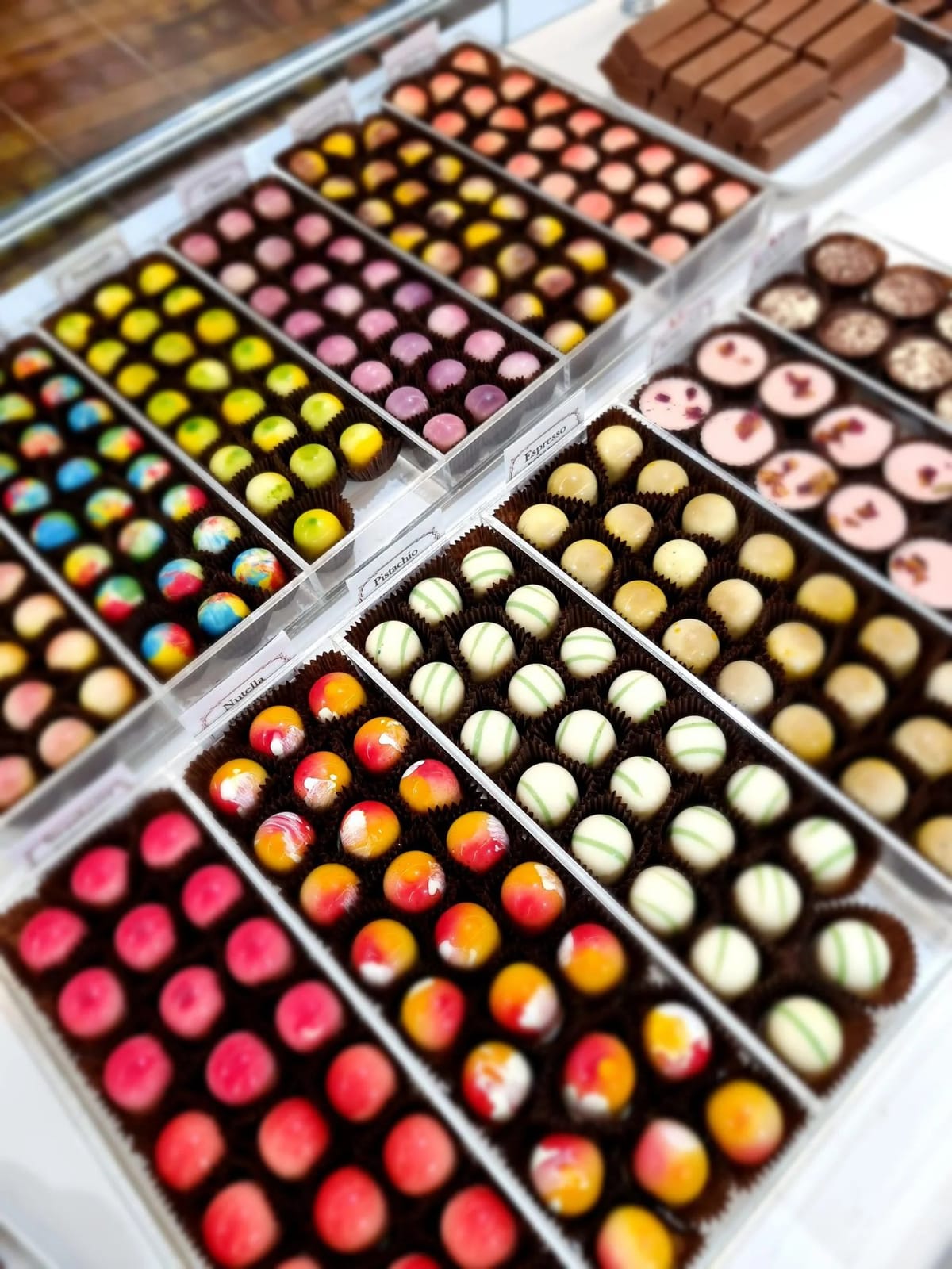 Display trays of colourful filled chocolates at Hunter Valley Chocolate Company, Pokolbin, Hunter Valley