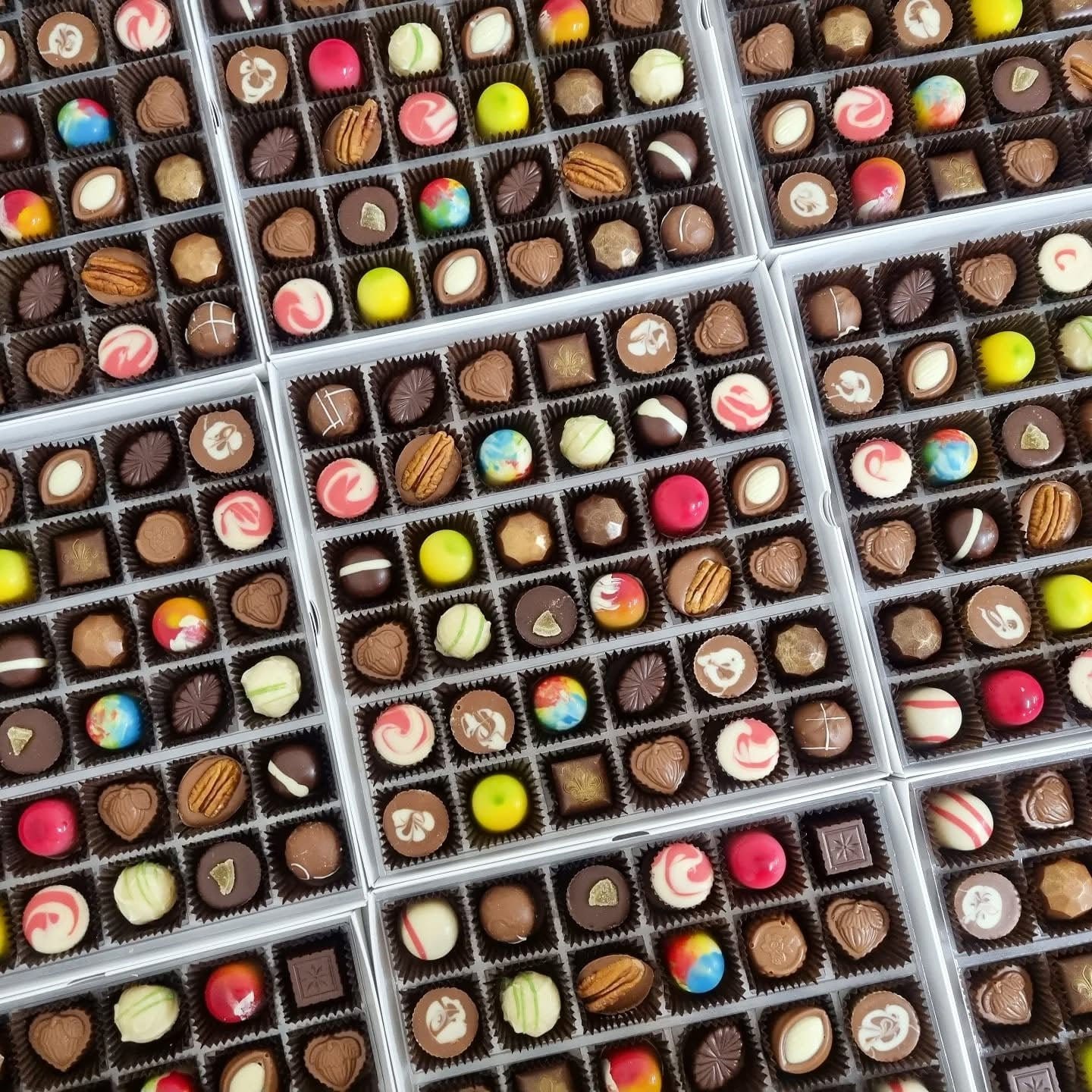 Multiple chocolate assortment boxes showing handmade chocolates varieties