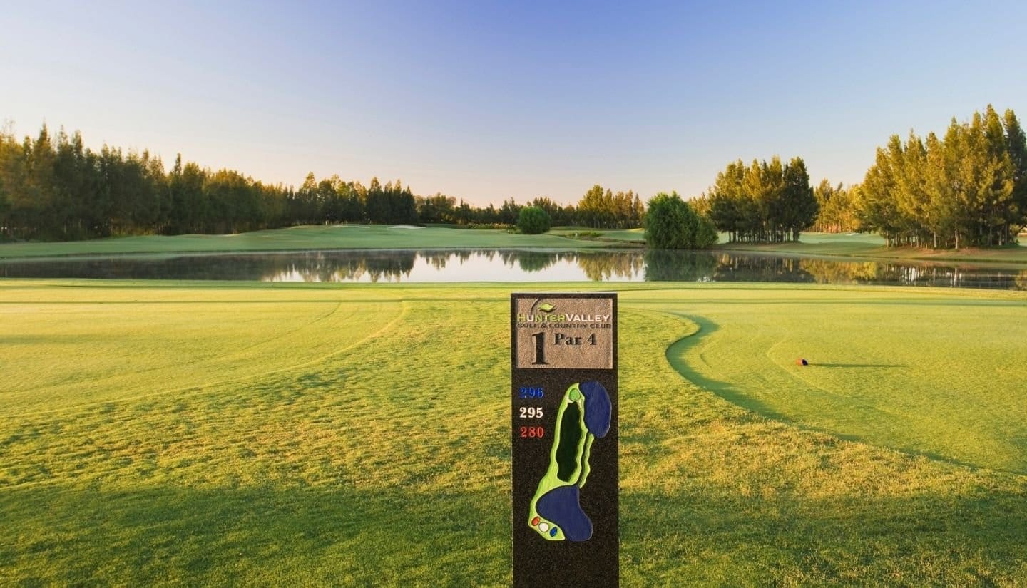 Course marker sign beside a lake on the fairway at Hunter Valley Golf Club.