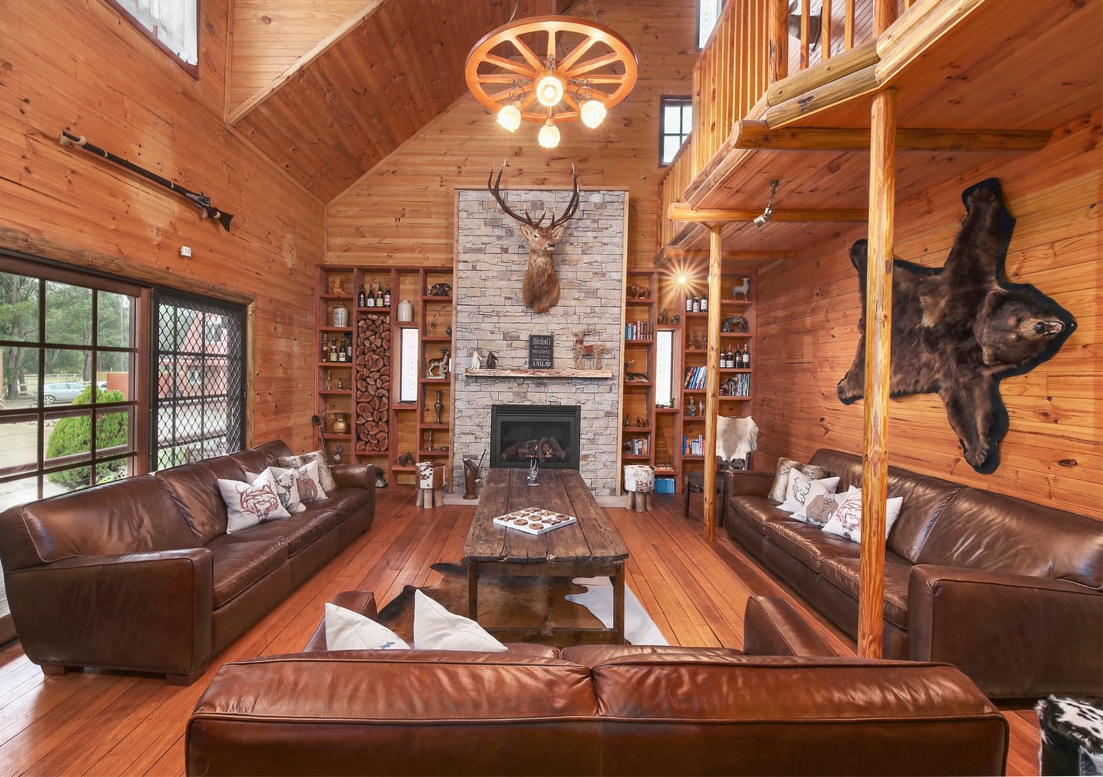 Log cabin lounge with stone fireplace at Hunter Valley Lodge and Retreat, Nulkaba, Hunter Valley