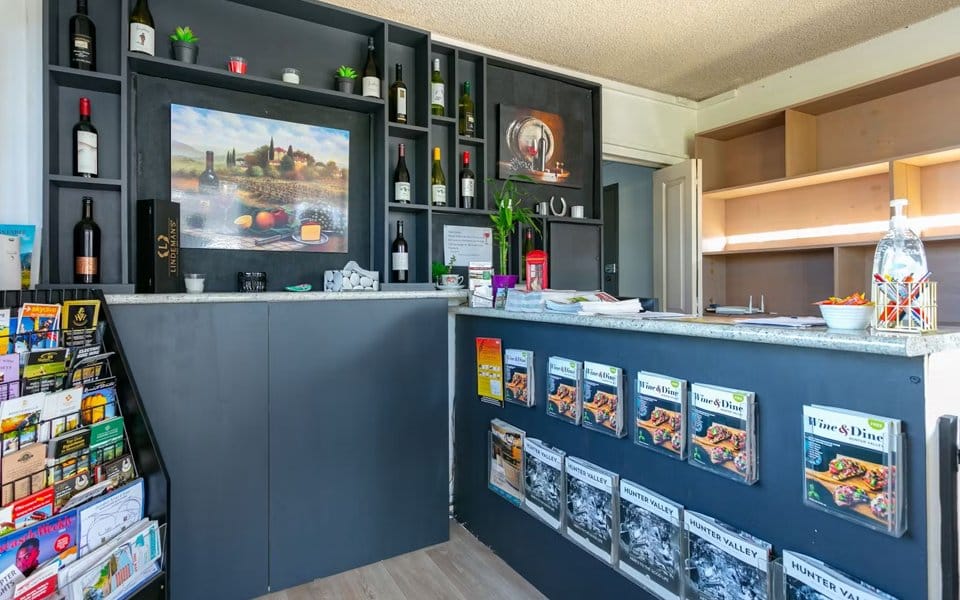 Reception desk and local information display at Hunter Valley Motel.