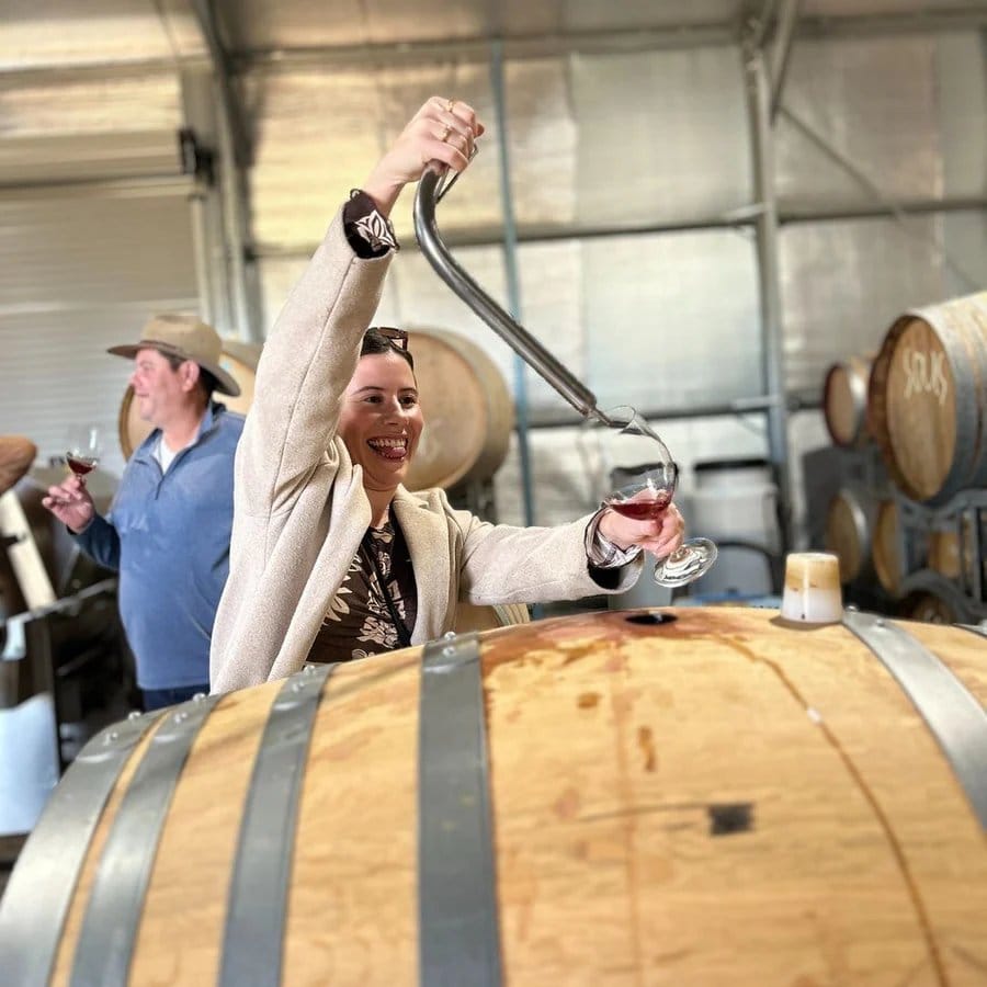 Visitor drawing wine from a barrel at Hunter Wine Lab, Pokolbin, Hunter Valley