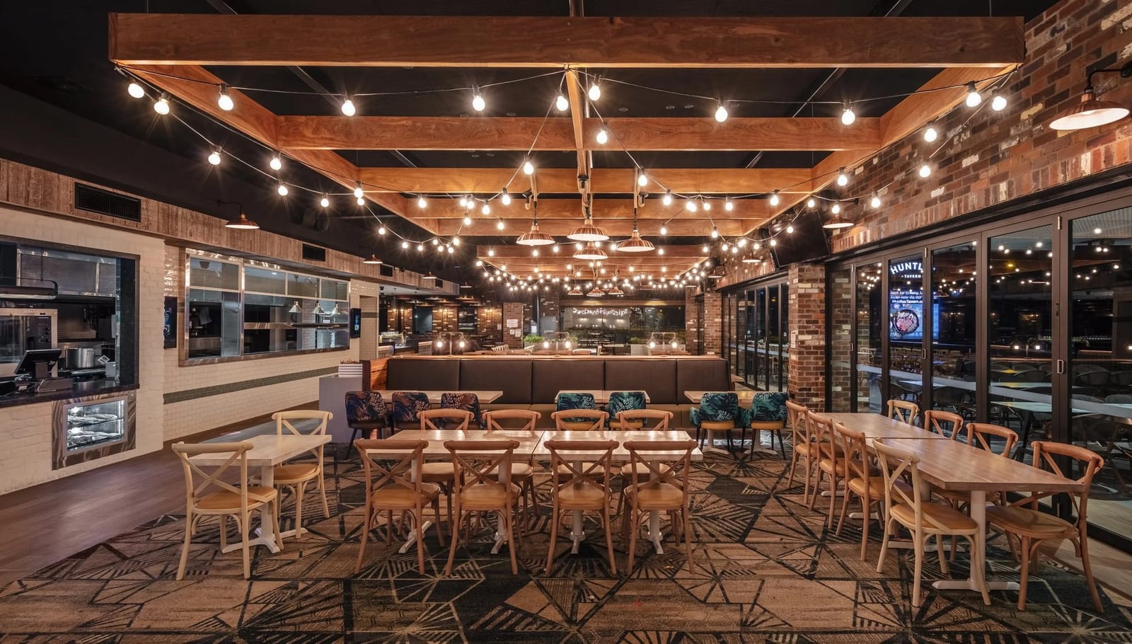 Dining room under festoon lights and timber beams at Huntlee Tavern, North Rothbury, Hunter Valley