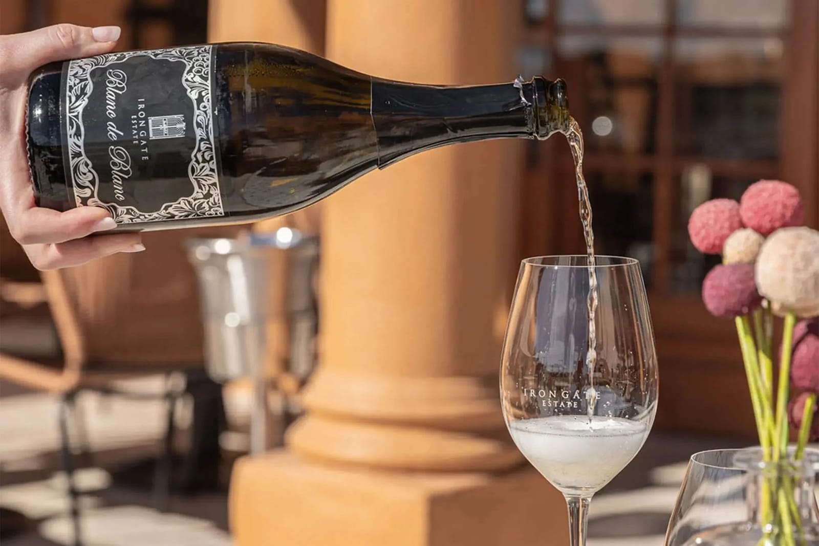 Iron Gate sparkling wine being poured on restaurant terrace at Iron Gate Kitchen, Pokolbin, Hunter Valley