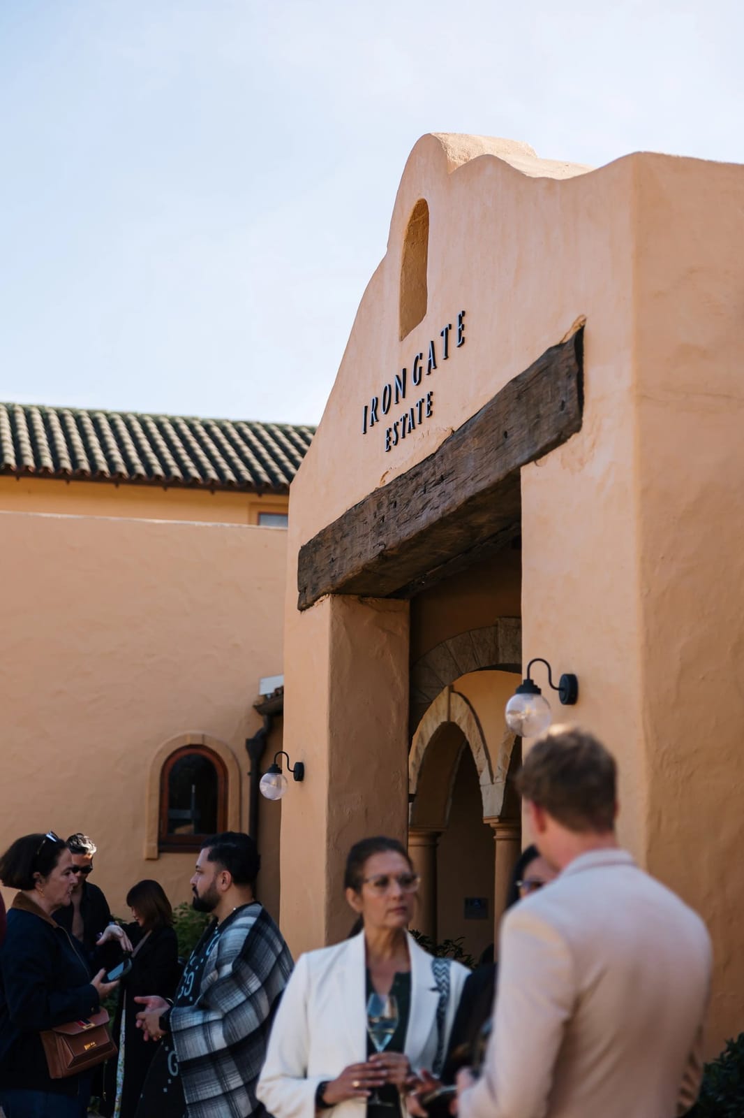 Terracotta building entrance with visitors gathered at Iron Gate, Pokolbin, Hunter Valley