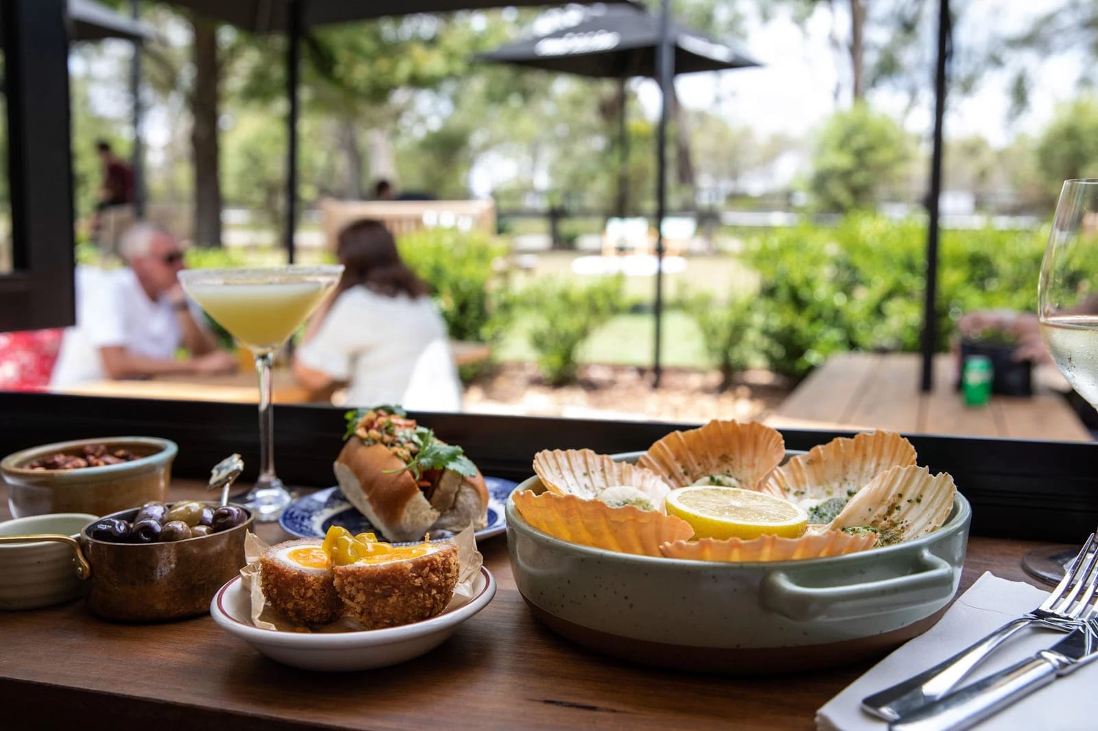 Restaurant dining with seafood and charcuterie platter at outdoor setting