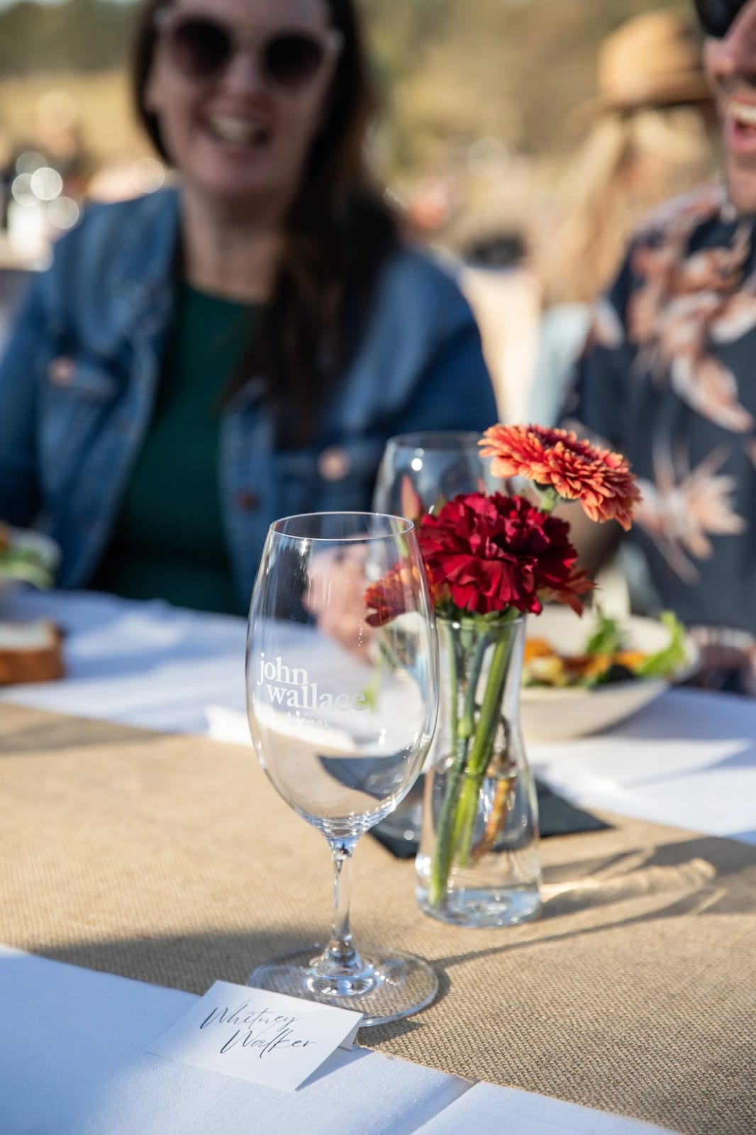 Table setting for wine tasting with branded glass and fresh flowers