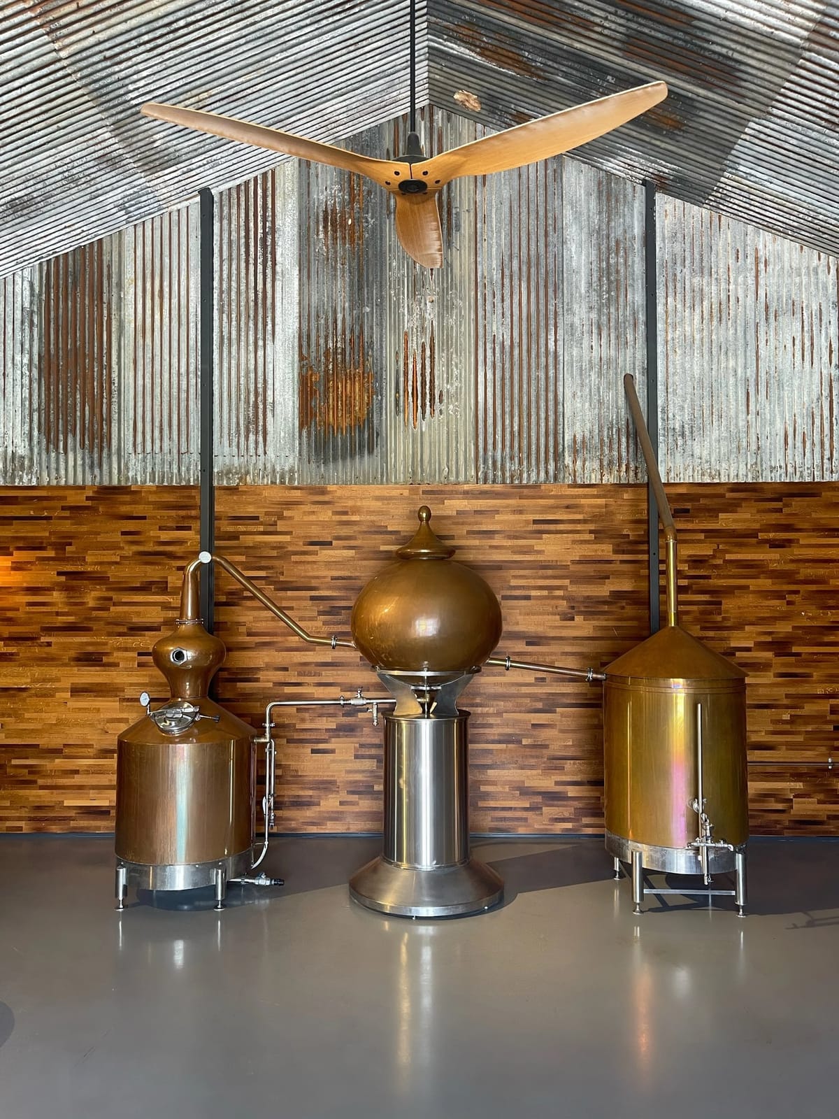 Distillery interior with copper stills and wooden floors at Kawal Rock Distillery, Milbrodale, Hunter Valley