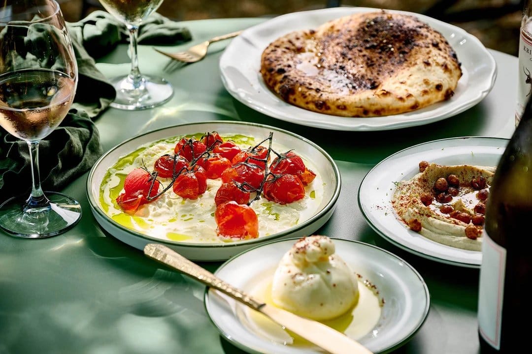 Italian food platters with tomato dish and baked pizza