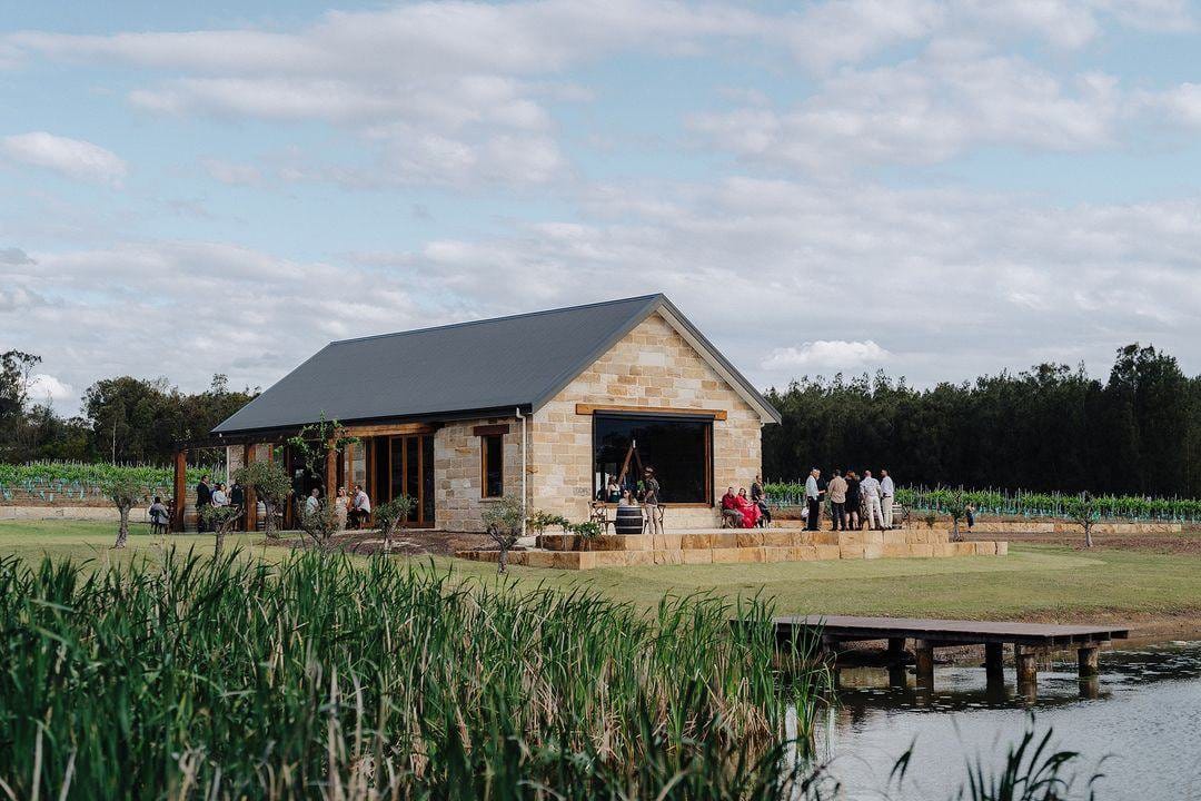 Stone chapel building beside the pond and vineyard at La Vigna Estate