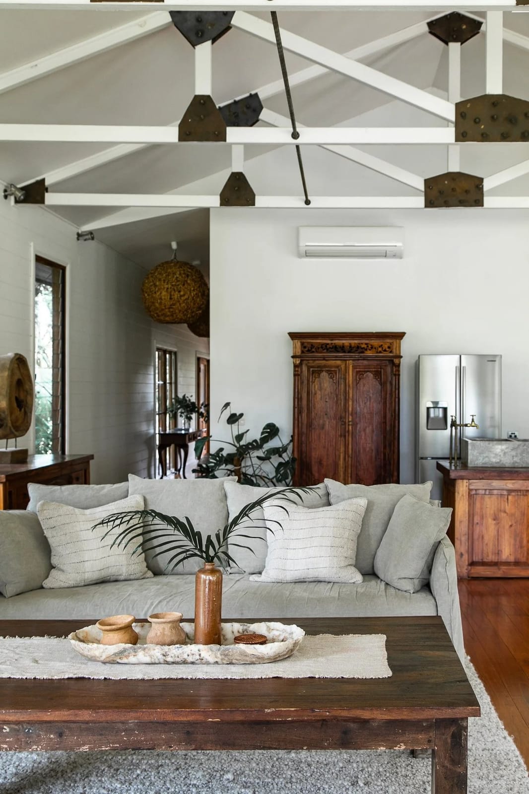 The living room in The Villa under a vaulted white ceiling