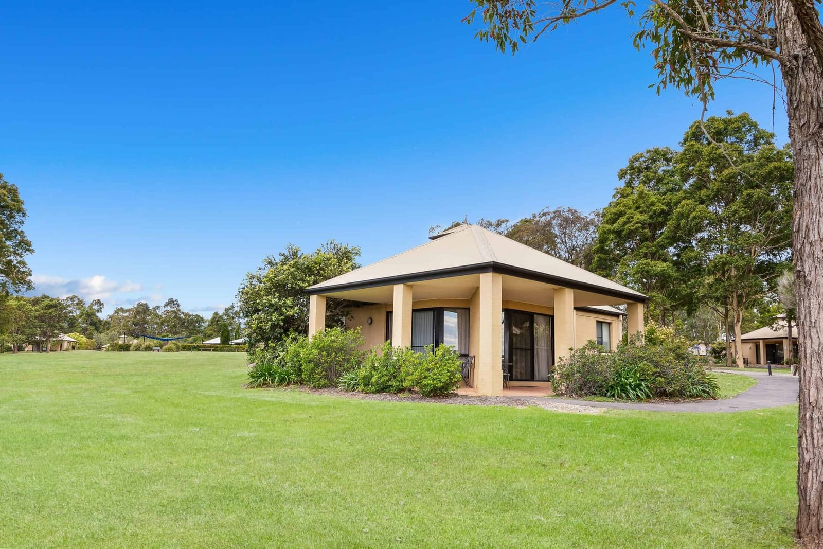 Villa with covered verandah on open lawn at Leisure Inn Pokolbin Hill, Pokolbin, Hunter Valley