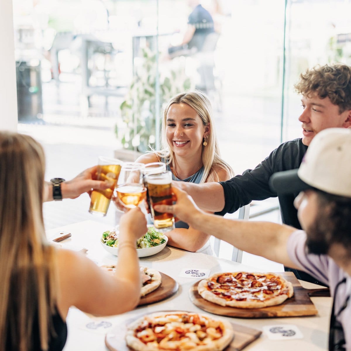 Friends clinking drinks over a meal