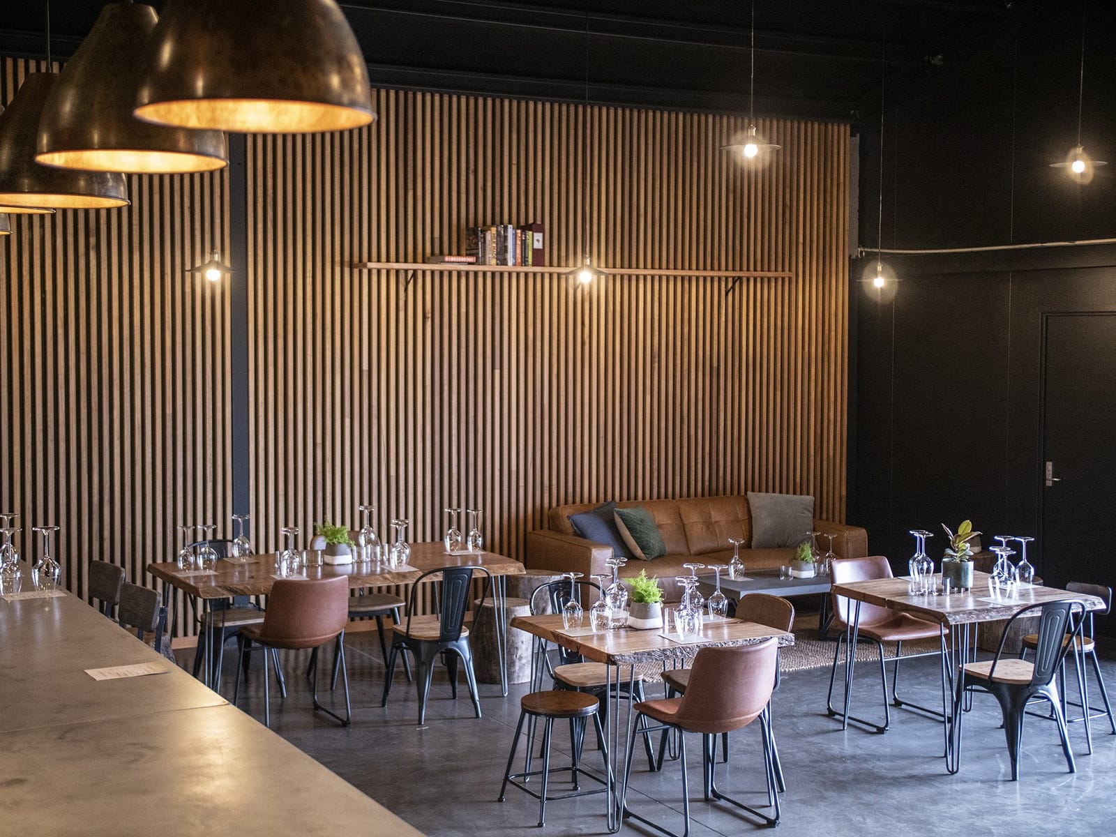 Modern tasting room with wooden walls and pendant lighting