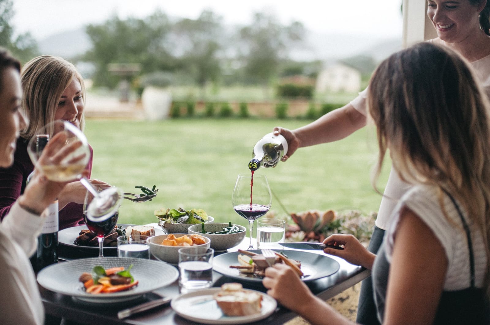 Outdoor dining with vineyard views and food service