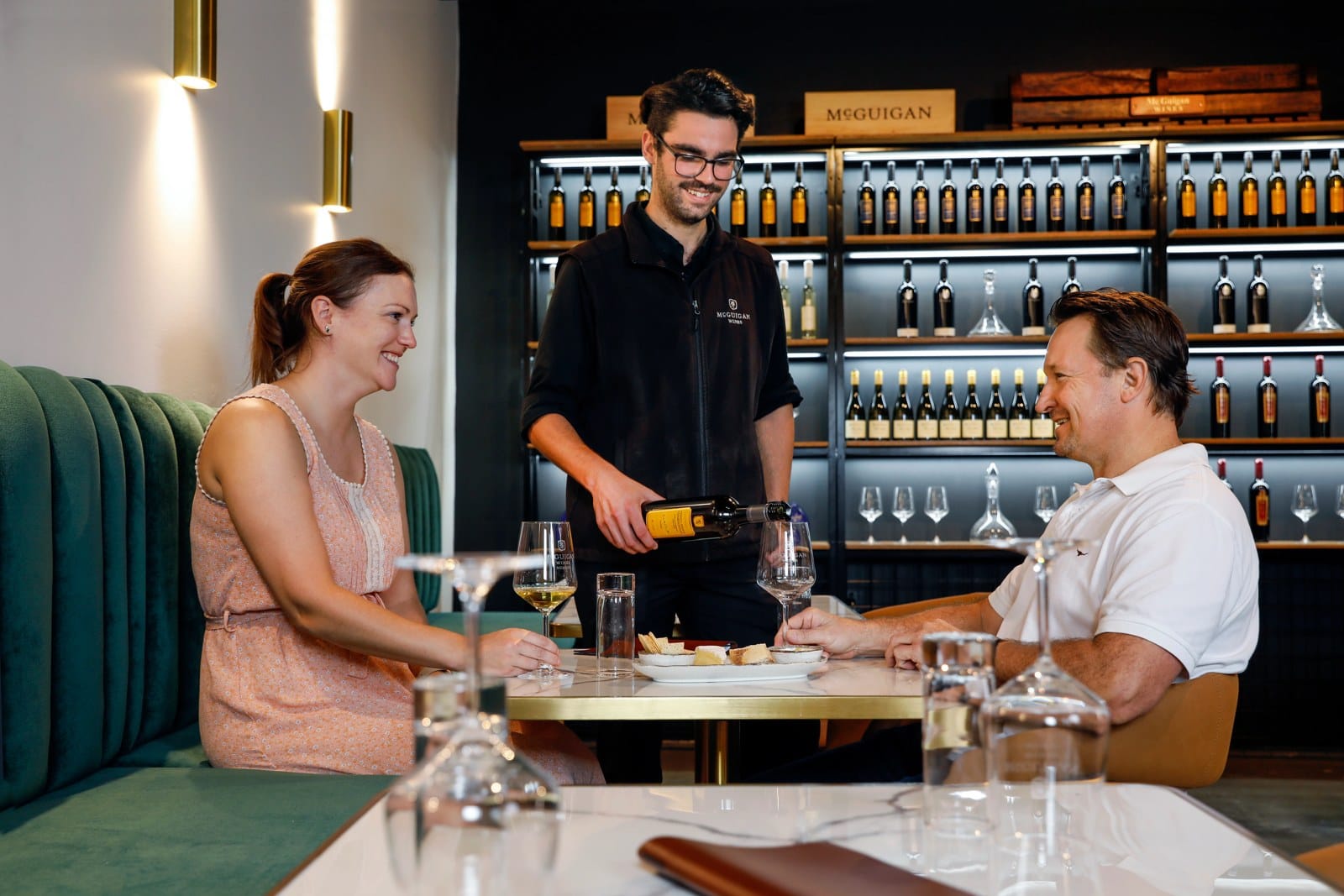 Staff serving wine to guests at the McGuigan cellar door