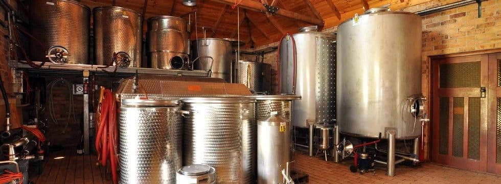 Winery production space with metal fermentation tanks