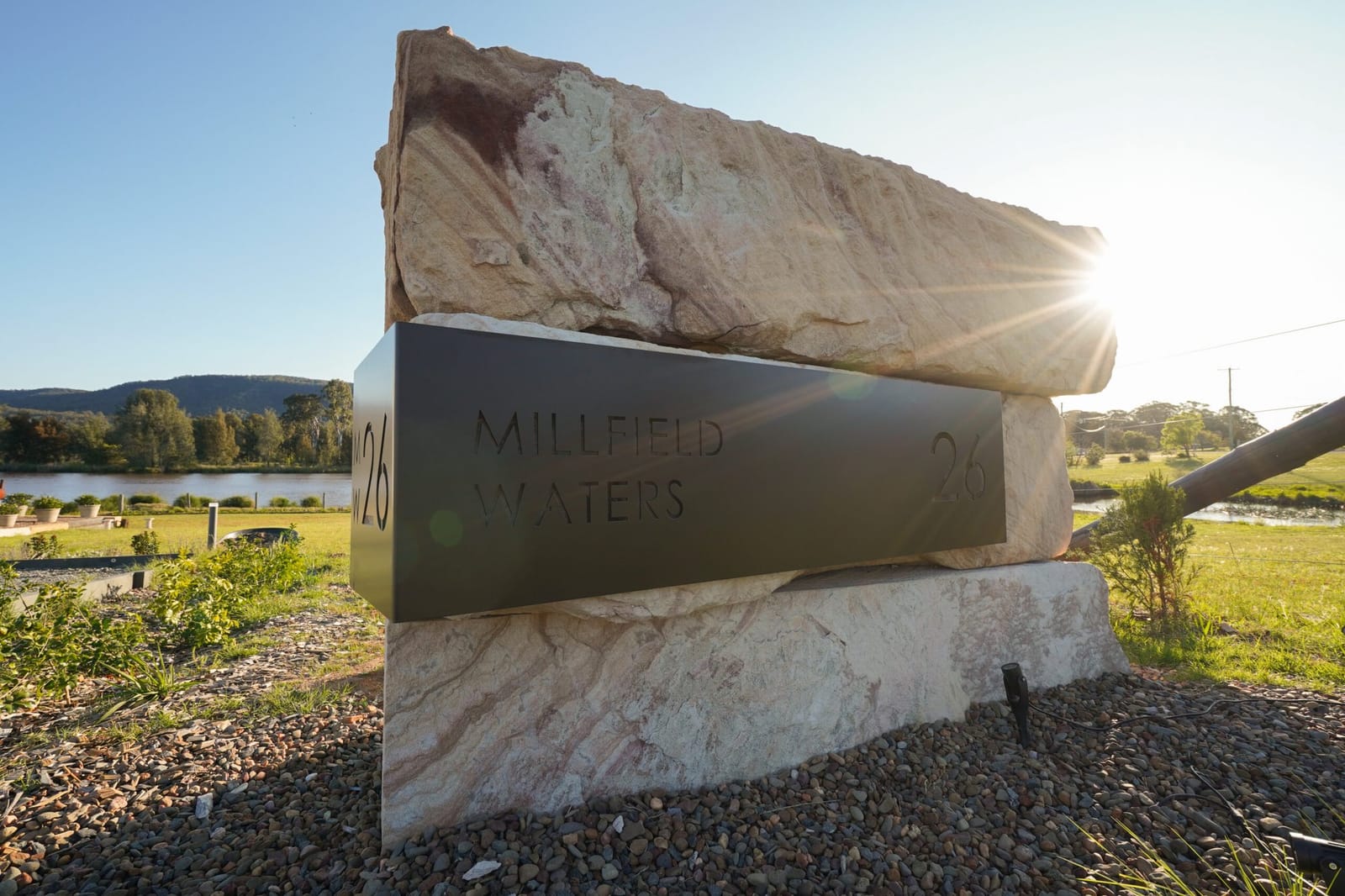 The sandstone entry marker at the driveway