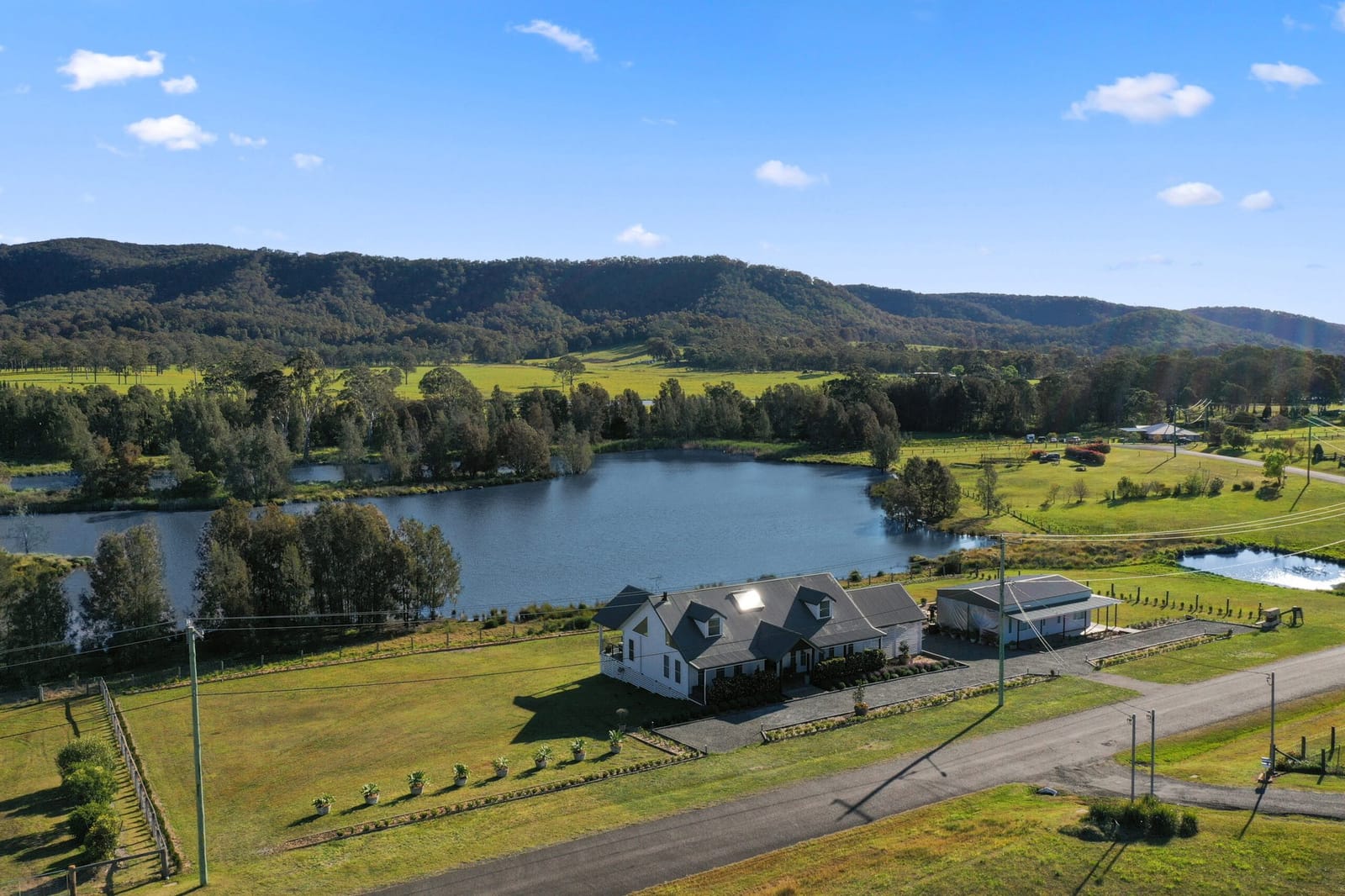 The house and its dam seen from the air with the valley behind