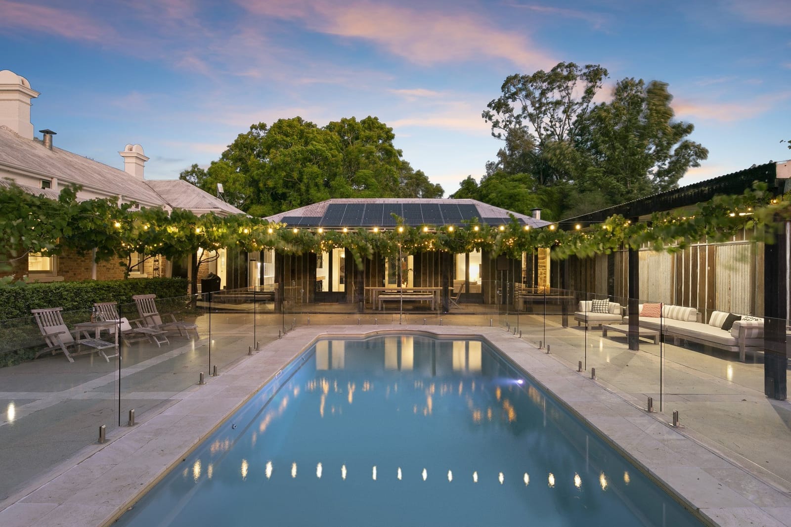 Pool and vine-covered pergola at dusk at Mindaribba House, Tocal, Hunter Valley