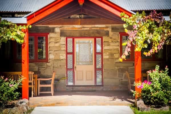 Red-trimmed sandstone entrance porch at Monkey Place Country Estate, Broke, Hunter Valley
