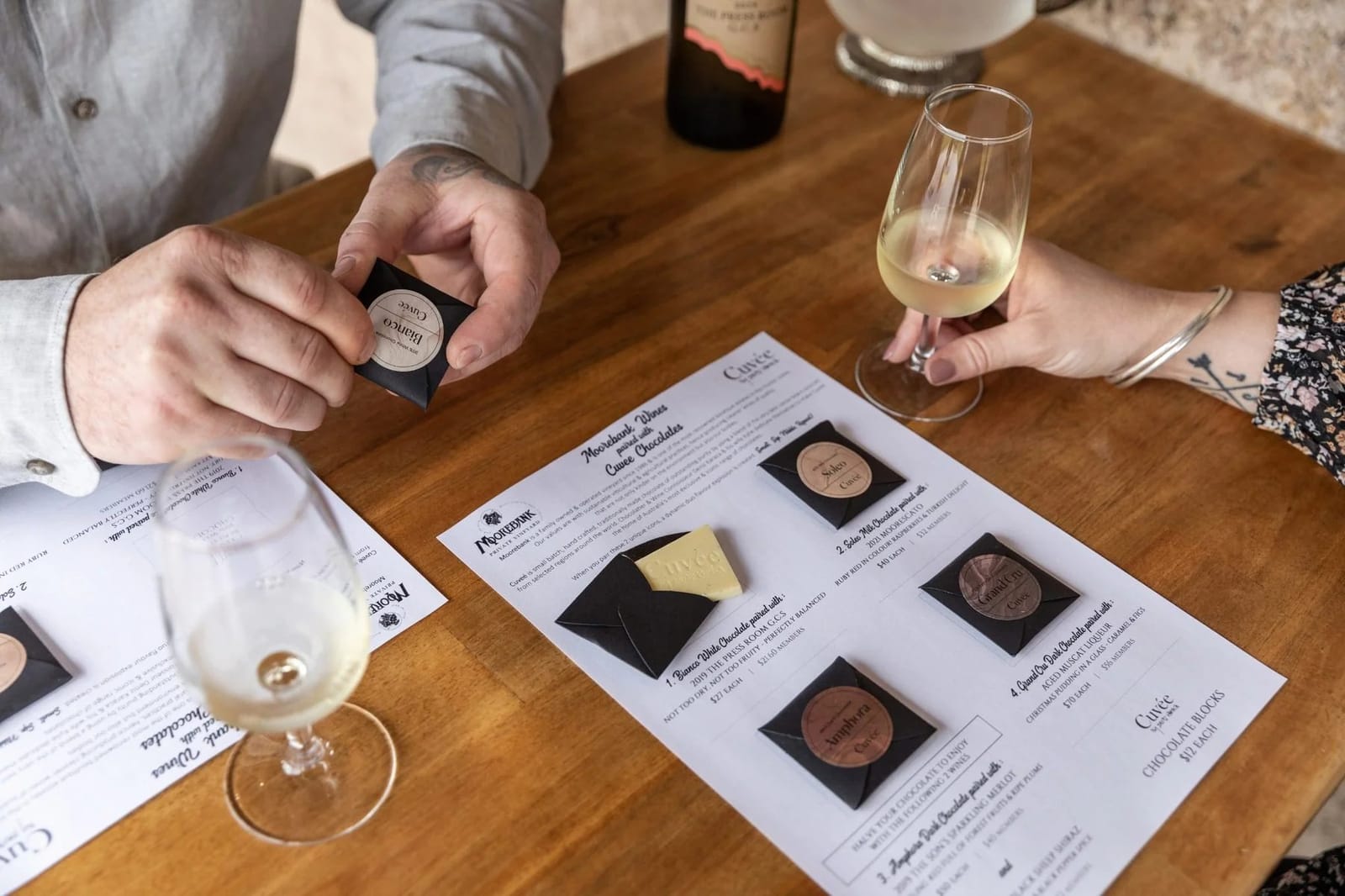 Two people holding wine glasses during cellar door tasting event
