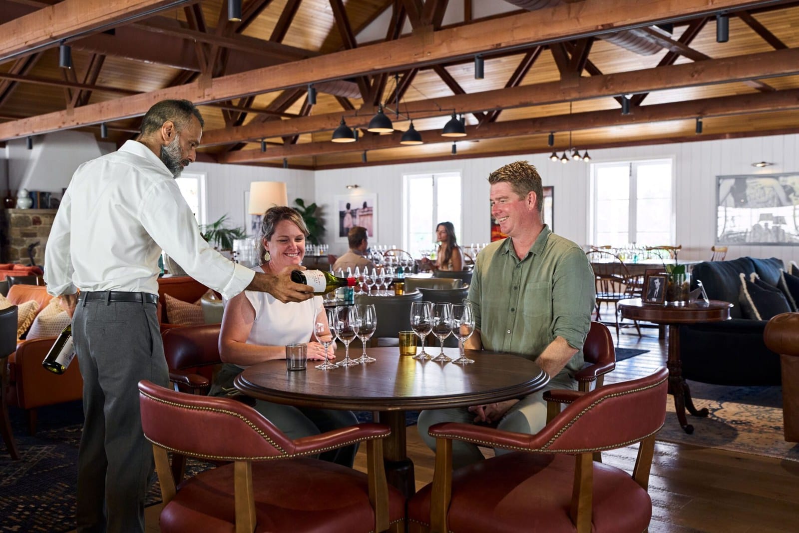 Guests being served a tasting in the timber-beamed Mount Pleasant cellar door