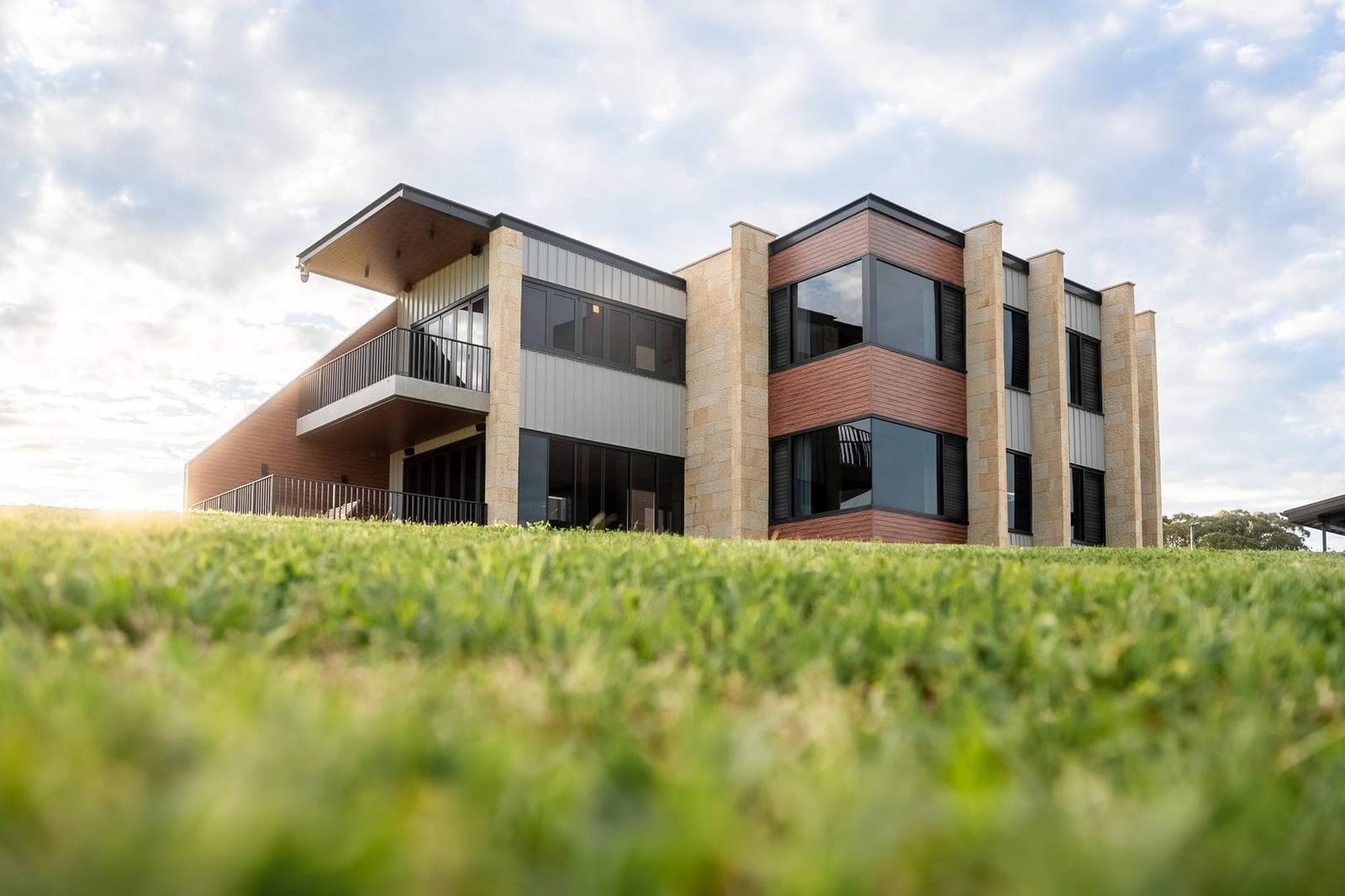 The Lodge building above the vineyard grass