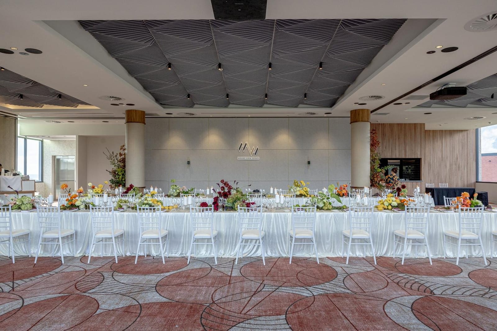 A long table set with flowers in the estate function room