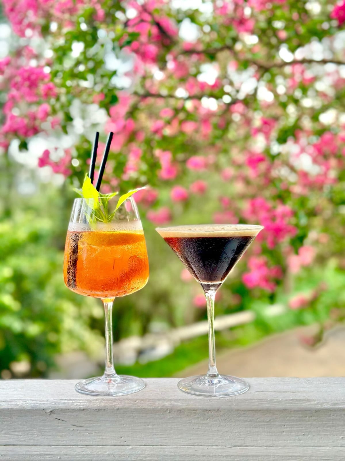 Cocktails on the rail at Myrtle and Stone, with blossom behind