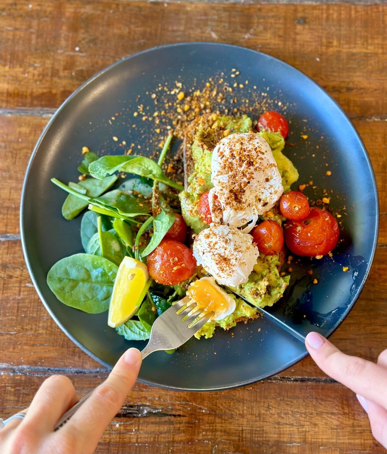 A poached egg and avocado breakfast plate at Myrtle and Stone