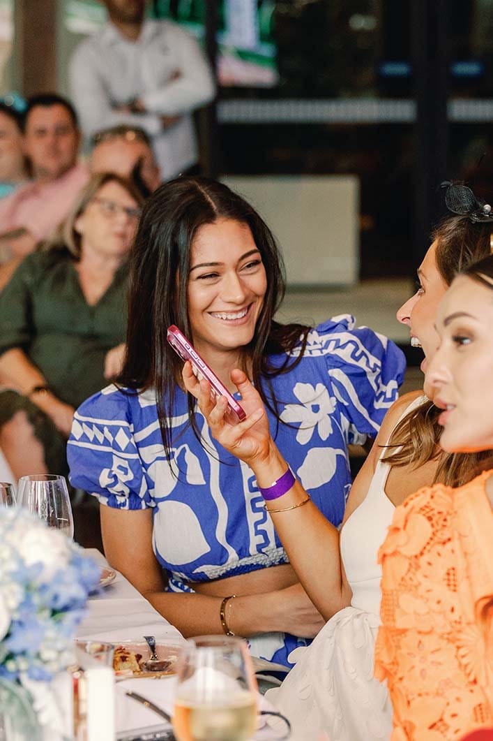 Two diners smiling and laughing at table during social event