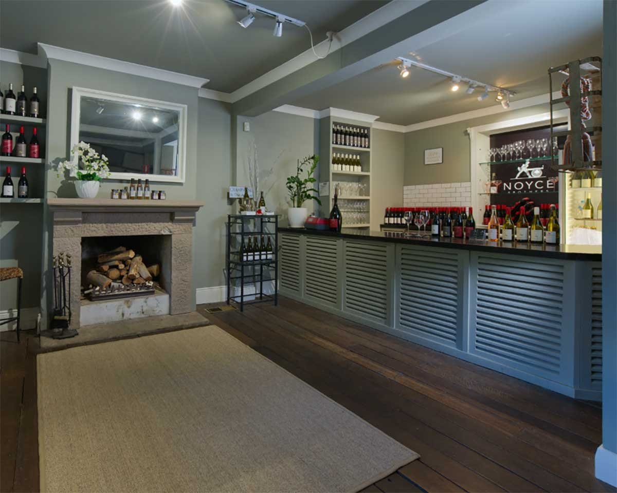 Tasting room with wine shelves, fireplace and seating