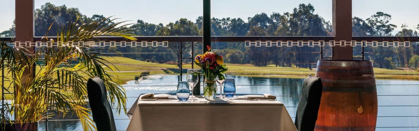 Dining table set on the terrace at Oak and Vine Cypress Lakes overlooking the lake and golf course, Pokolbin, Hunter Valley