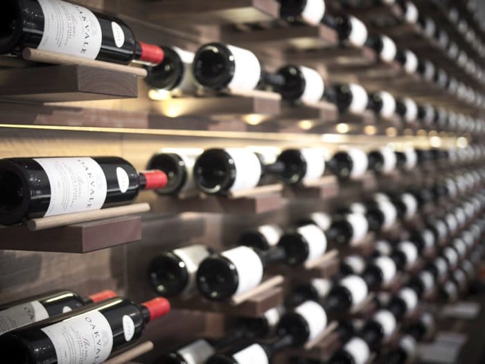Rows of Oakvale bottles racked on angled timber shelves