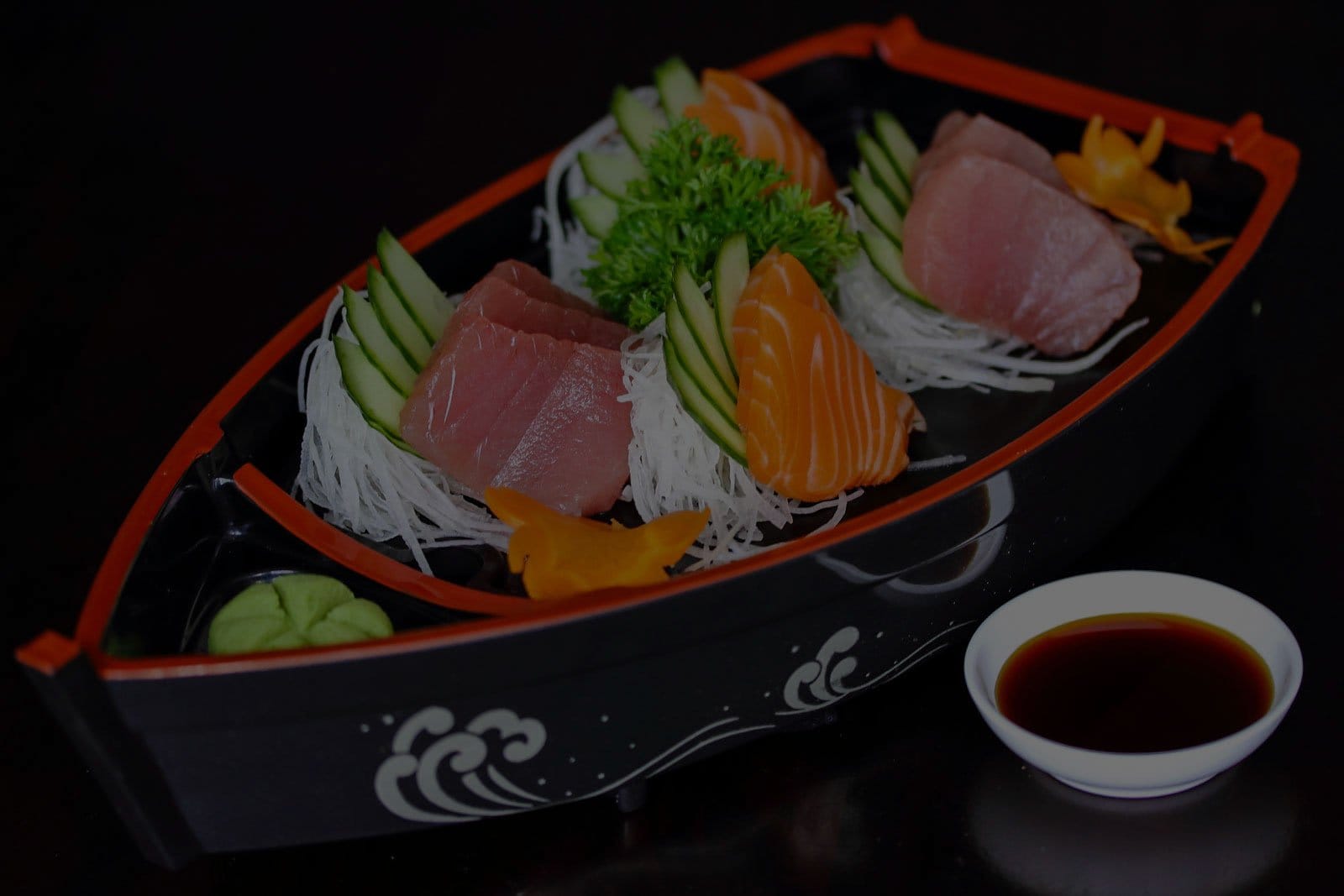 Sushi and sashimi platter with rice and dipping sauce