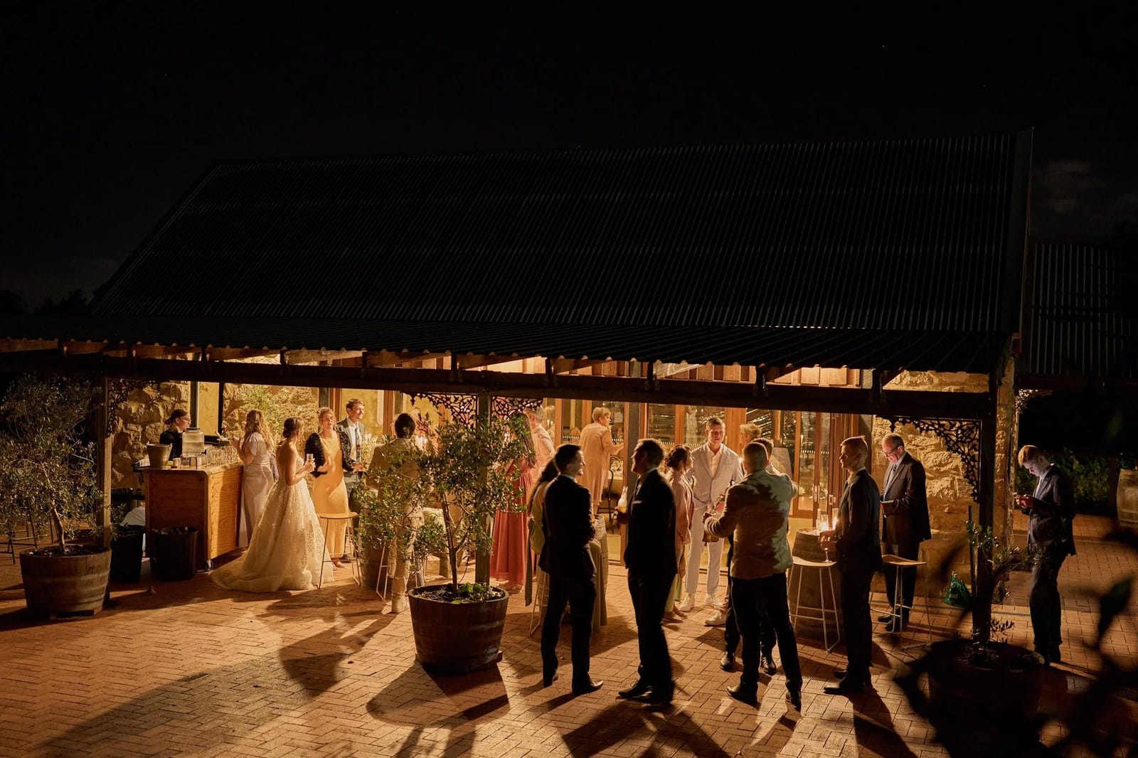 Wedding reception held in illuminated outdoor events space