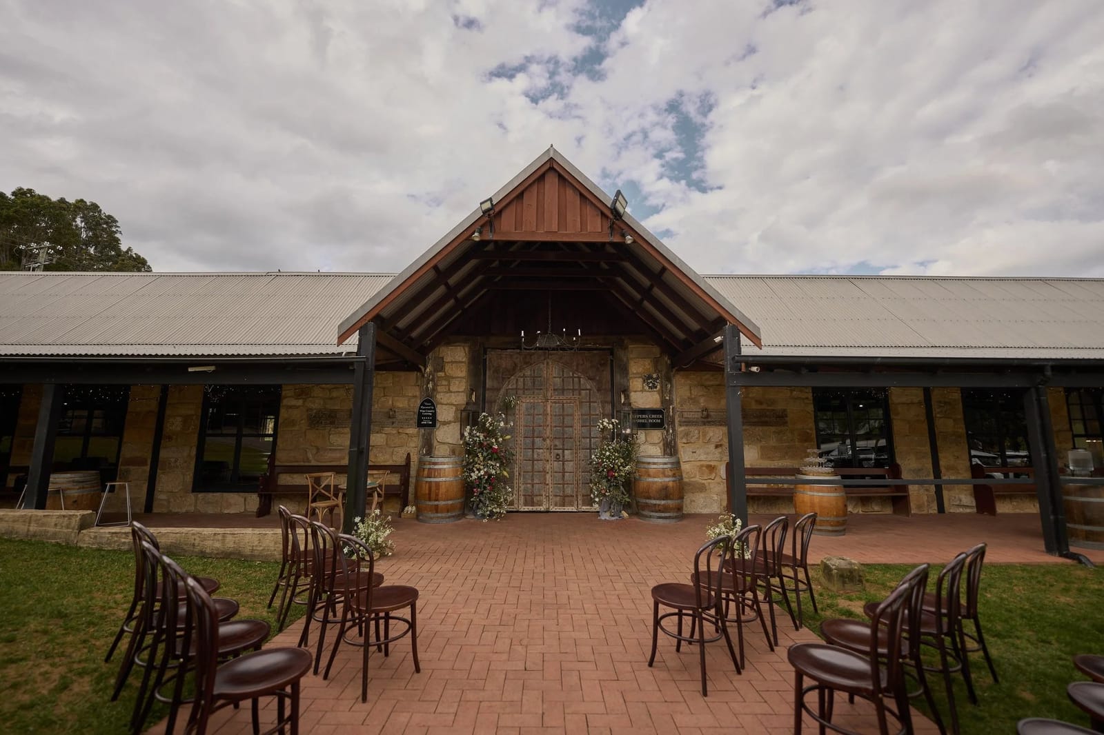 Stone cellar door building with timber doors at Peppers Creek Chateau, Pokolbin, Hunter Valley