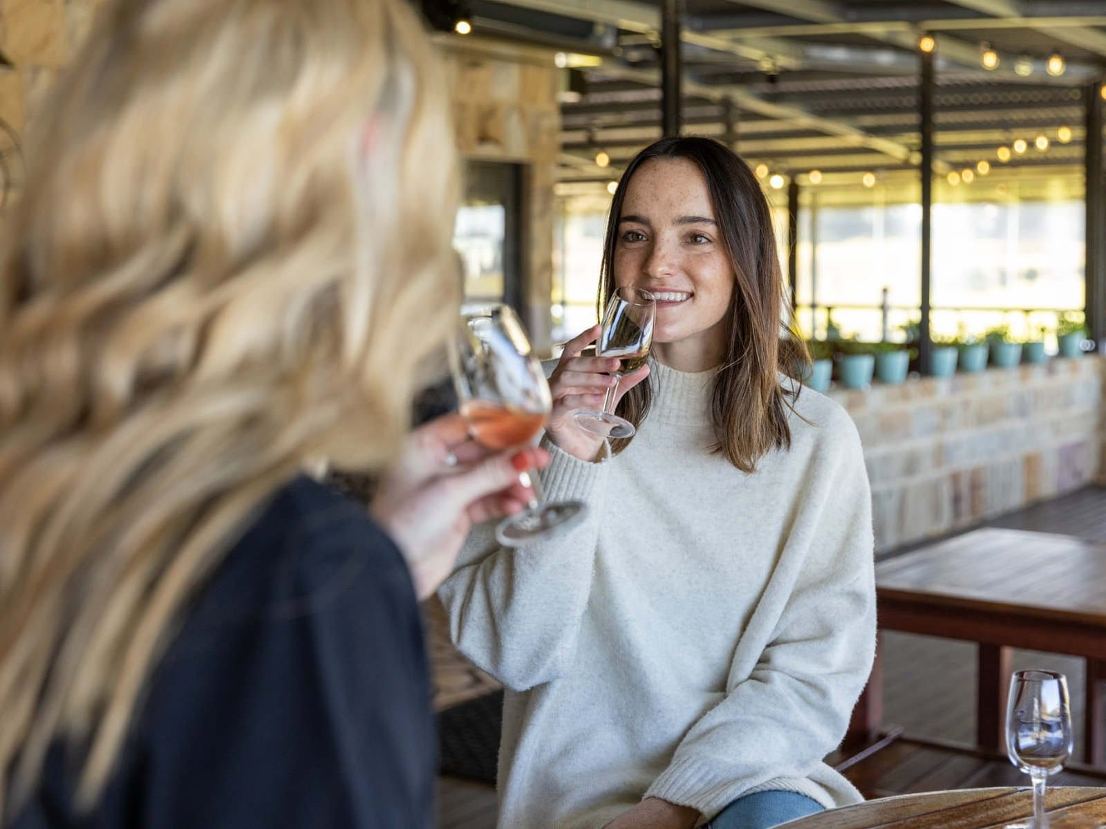 Woman sampling wine in modern tasting room at Peterson House, Pokolbin, Hunter Valley