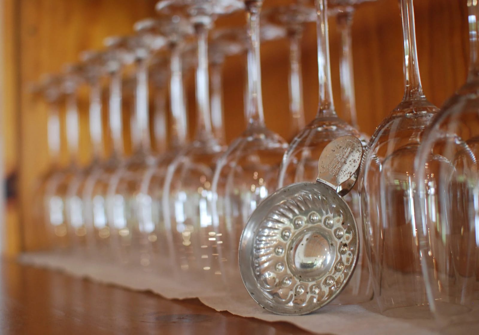 Line of wine glasses with ornate metal holders arranged for tasting