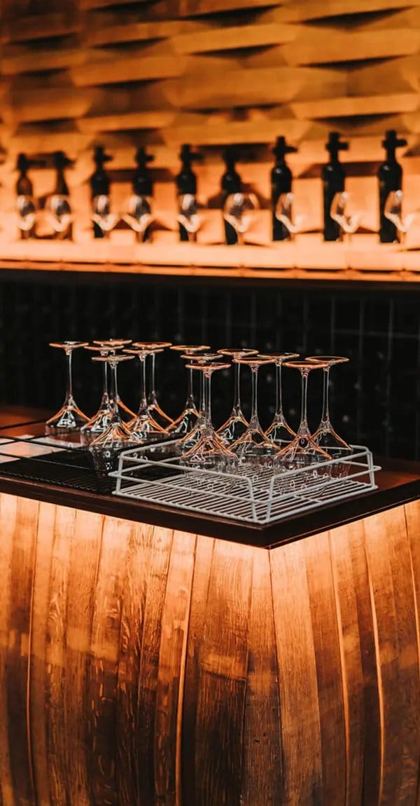 Wine tasting glasses with oak barrels at Piggs Peake, Pokolbin, Hunter Valley