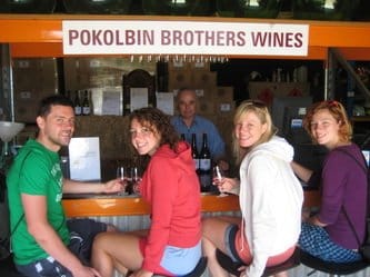 Visitors at cellar door counter with Pokolbin Brothers signage