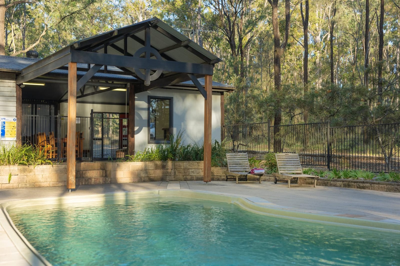 The swimming pool and covered pavilion behind one of the cottages