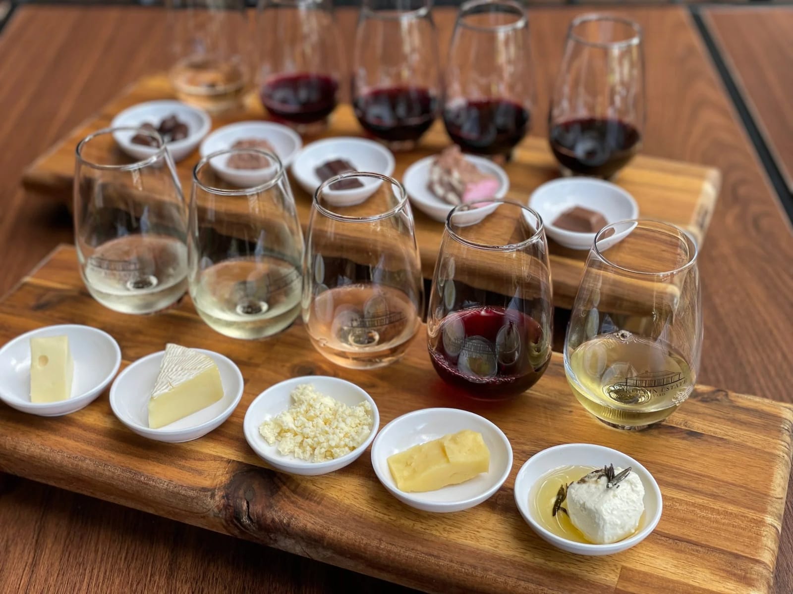 Wine flight with cheese and fruit pairings on table